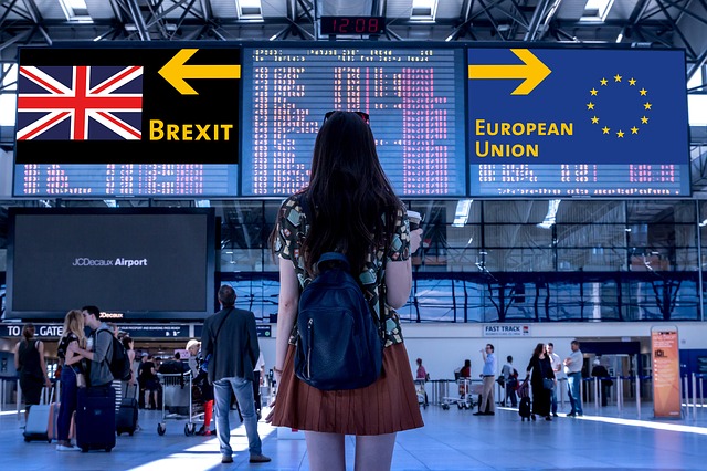 woman at airport with brexit and eu signs