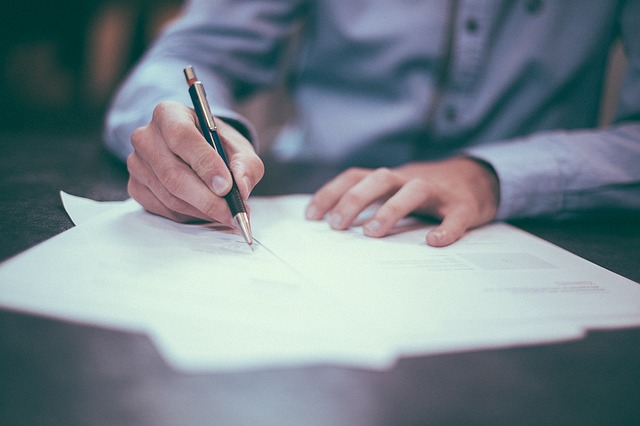 man writing a letter